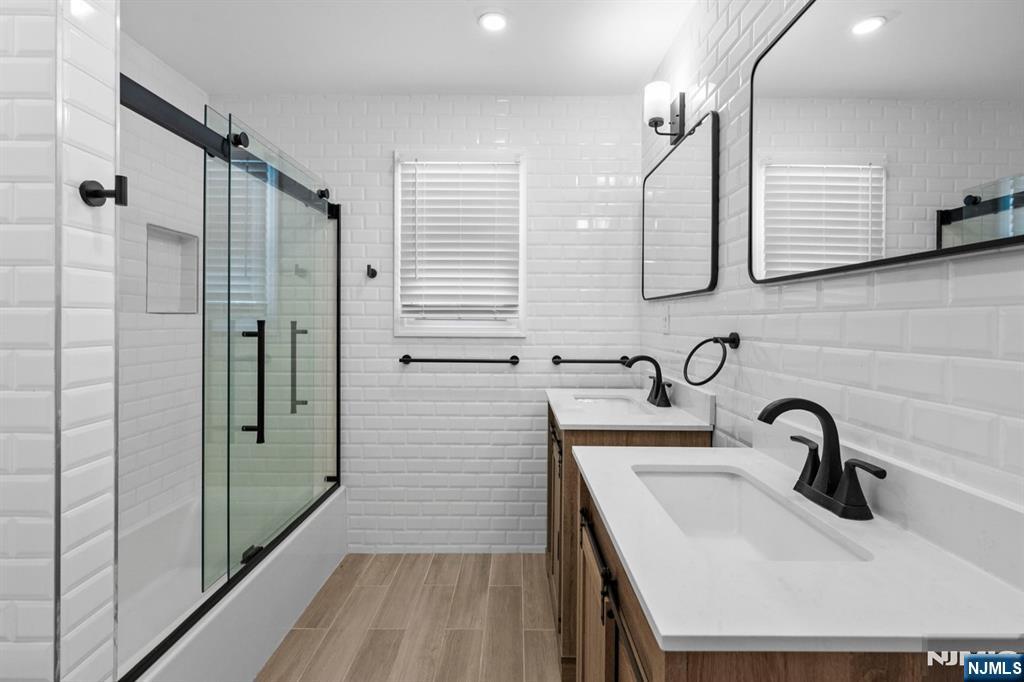 301 New Bridge Road Bergenfield, NJ 07621 - Photo 16 of 27 a bathroom with a sink and mirror