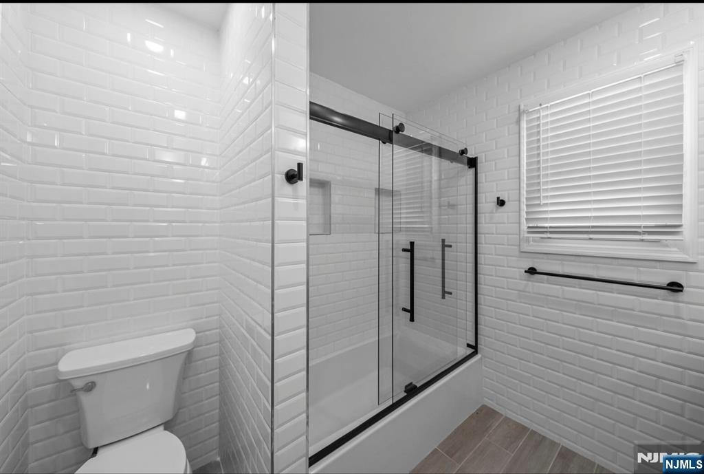 301 New Bridge Road Bergenfield, NJ 07621 - Photo 17 of 27 a bathroom with a shower toilet and sink