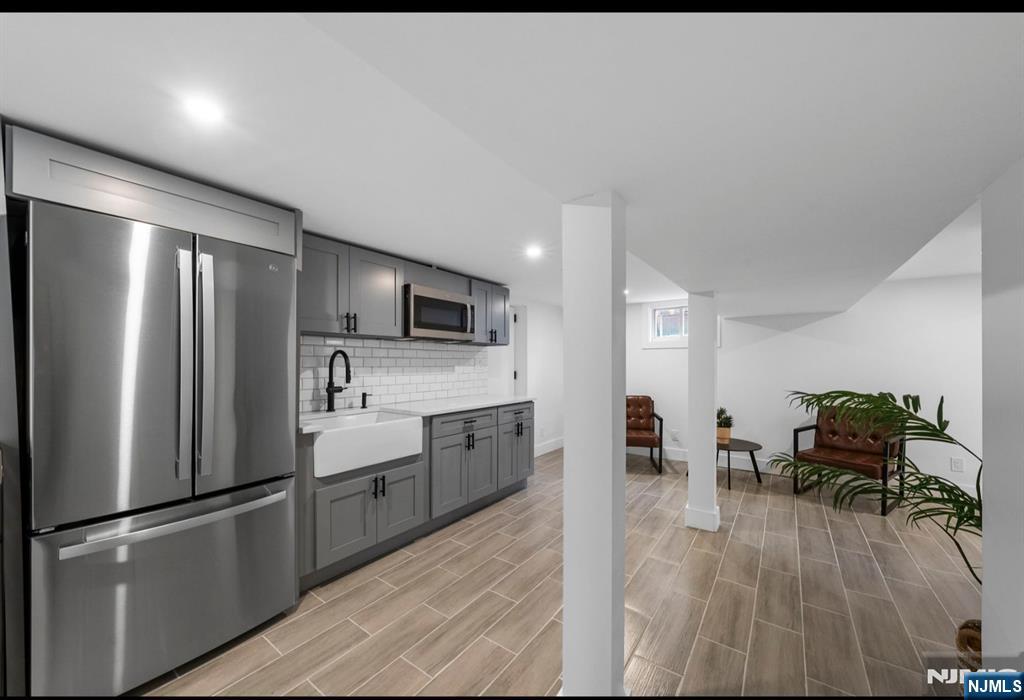 301 New Bridge Road Bergenfield, NJ 07621 - Photo 19 of 27 a kitchen with stainless steel appliances granite countertop a refrigerator a stove top oven a sink dishwasher and white cabinets with wooden floor