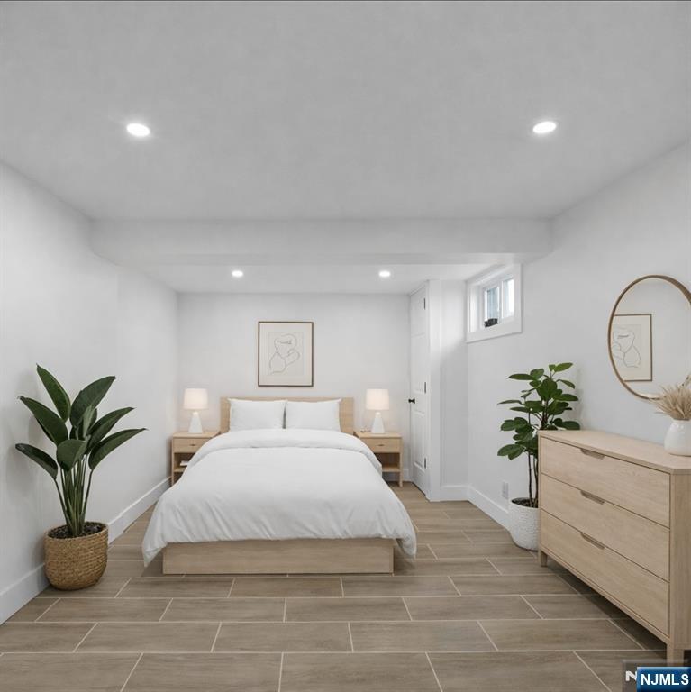 301 New Bridge Road Bergenfield, NJ 07621 - Photo 21 of 27 a bedroom with a large bed and a potted plant