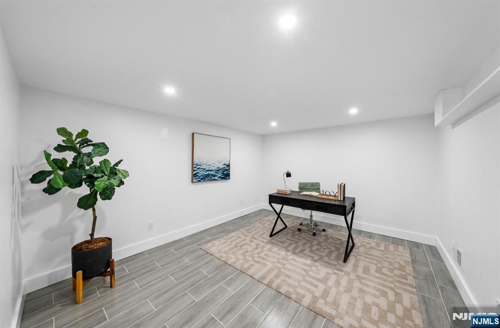 301 New Bridge Road Bergenfield, NJ 07621 - Photo 22 of 27 a living room with furniture and a potted plant