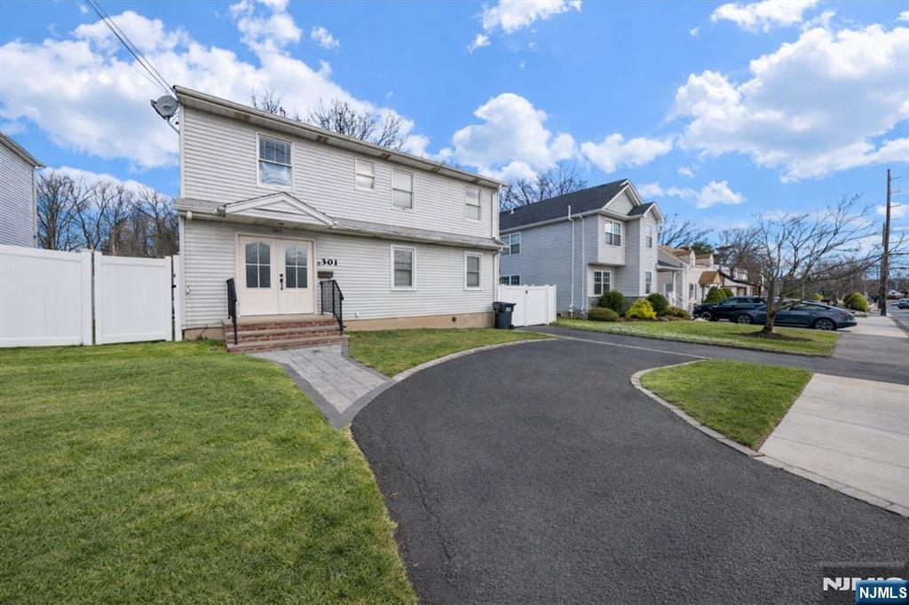 301 New Bridge Road Bergenfield, NJ 07621 - Photo 27 of 27 a view of a house with a big yard and a large tree