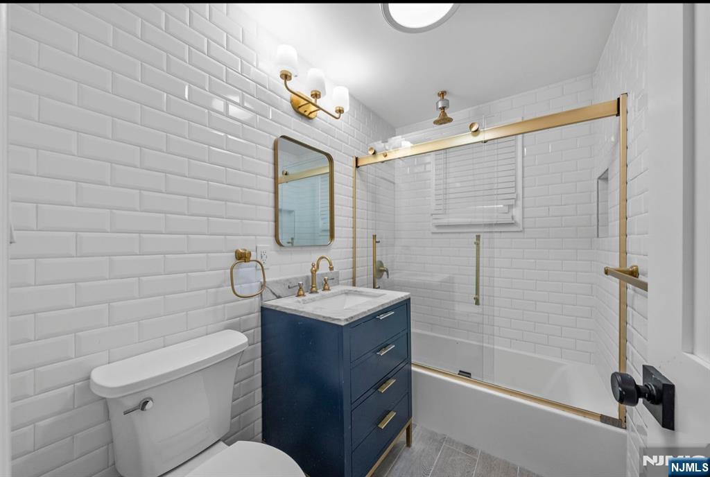 301 New Bridge Road Bergenfield, NJ 07621 - Photo 7 of 27 a bathroom with a sink a toilet and shower