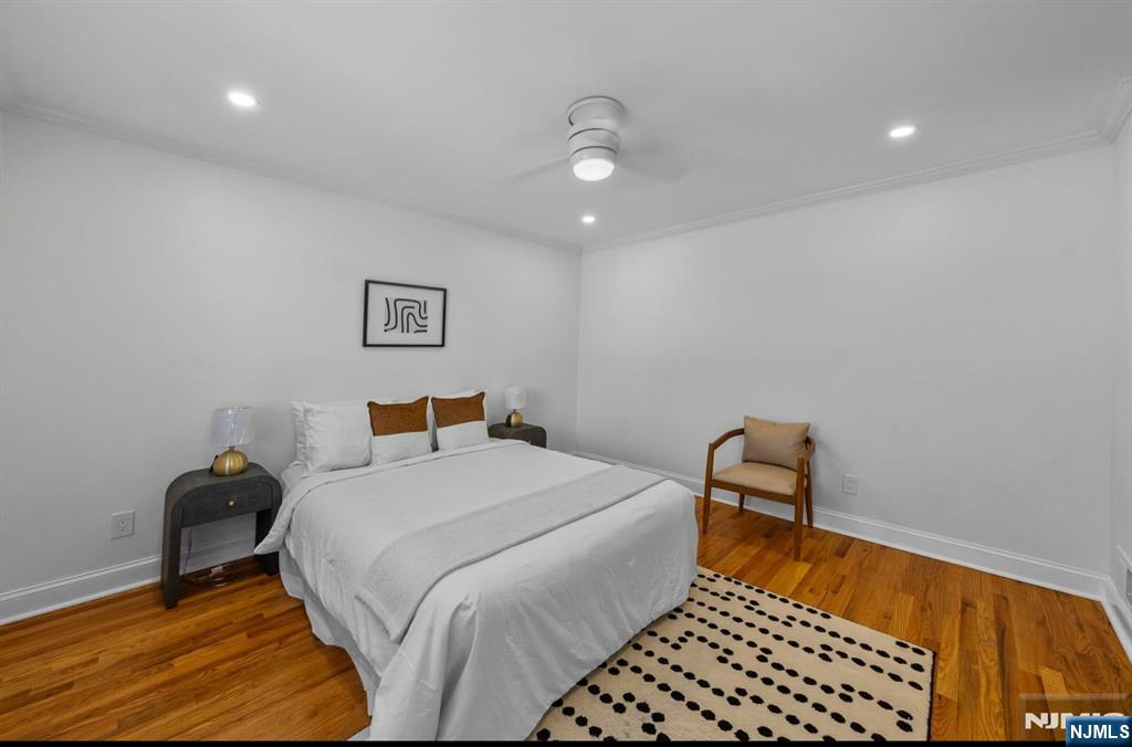 301 New Bridge Road Bergenfield, NJ 07621 - Photo 10 of 27 a bedroom with a bed and a chair
