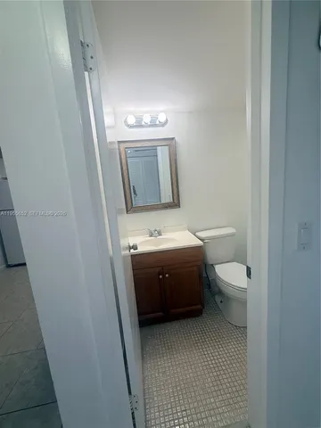 a bathroom with a toilet and a bath tub