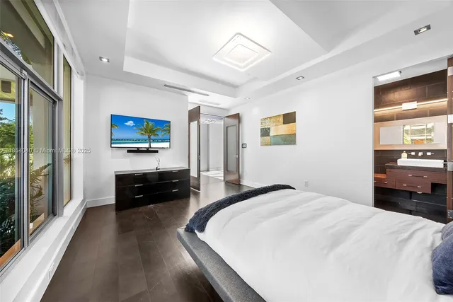 a dining room with furniture and a floor to ceiling window