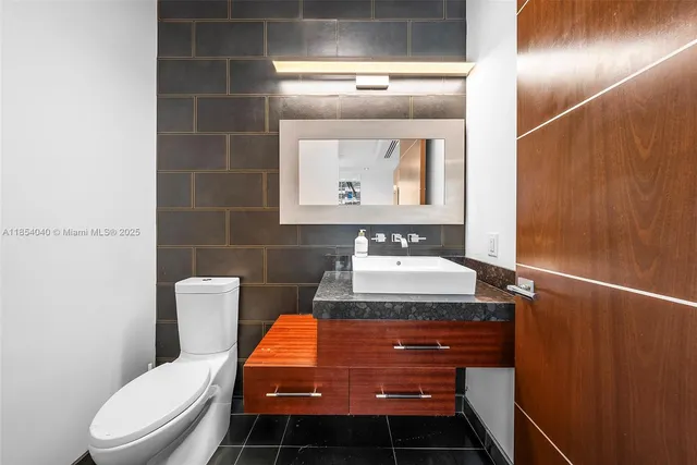 a kitchen with granite countertop a refrigerator and a stove top oven