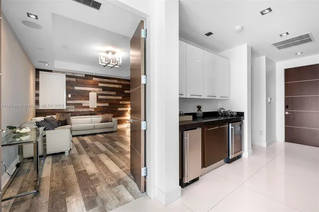 a living room with fireplace furniture and a large window