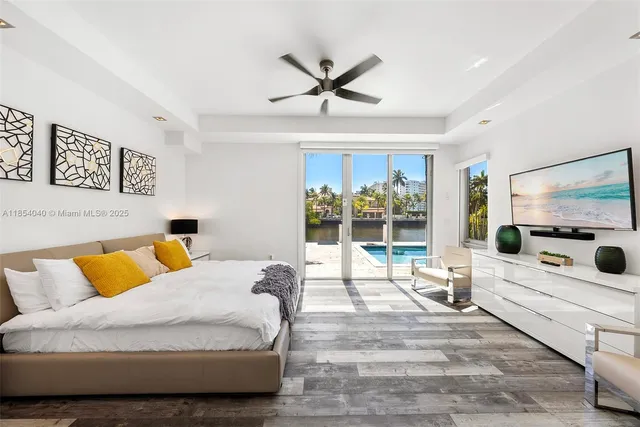 a living room with furniture and large windows