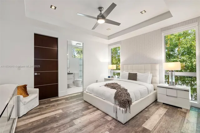 a view of a patio with table and chairs with wooden floor and fence