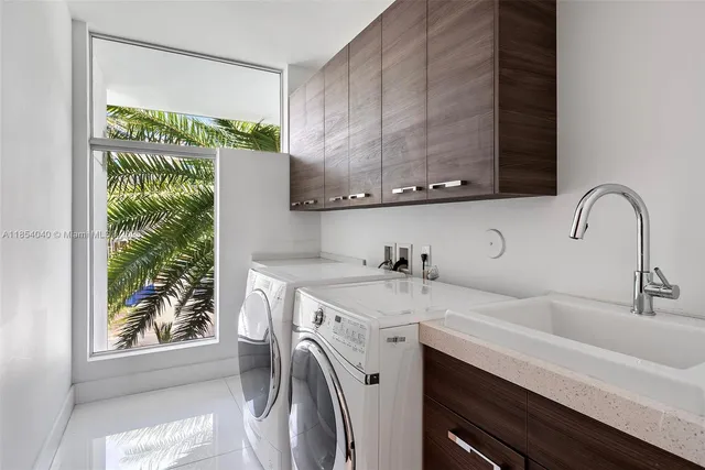 an aerial view of residential houses with outdoor space and lake view