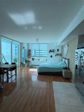 a bedroom with furniture and a wooden floor
