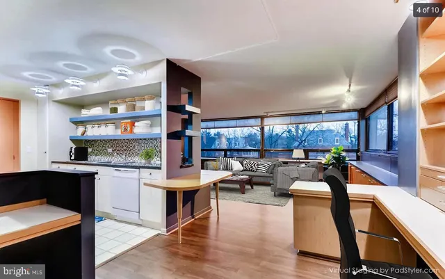 a living room with stainless steel appliances kitchen island granite countertop furniture and a kitchen view
