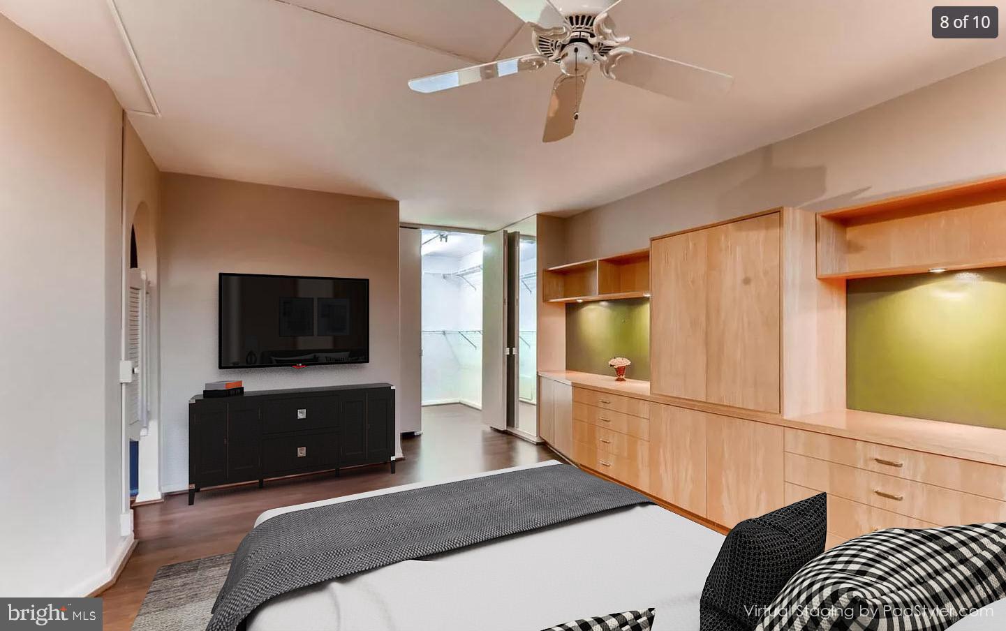 4000 North Charles Street, Unit 312 Baltimore, MD 21218 - Photo 5 of 19 a bedroom with furniture and a flat screen tv