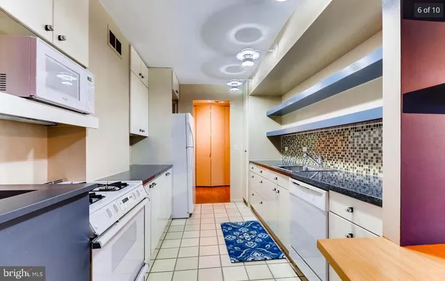 a open kitchen with stainless steel appliances granite countertop a sink and cabinets