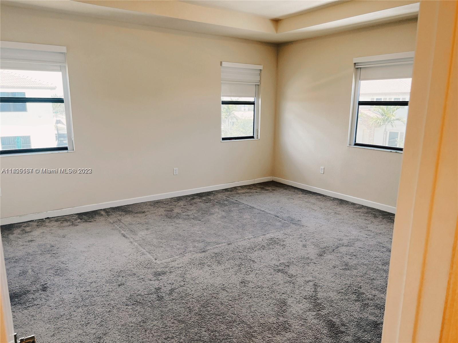 24022 Southwest 117 Path Homestead, FL 33032 - Photo 8 of 10 an empty room with windows and closet