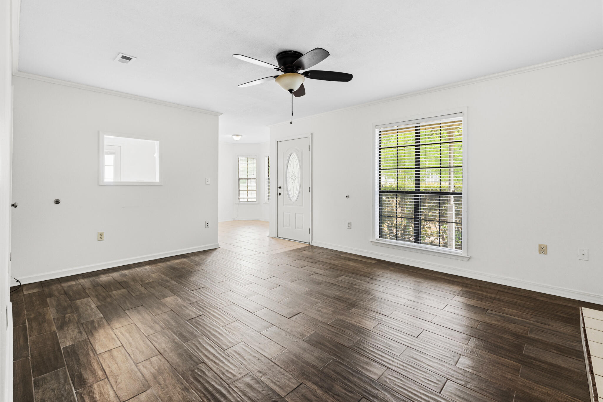 207 Pinoak Court Crestview, FL 32539 - Photo 3 of 33 wooden floor in an empty room with a window