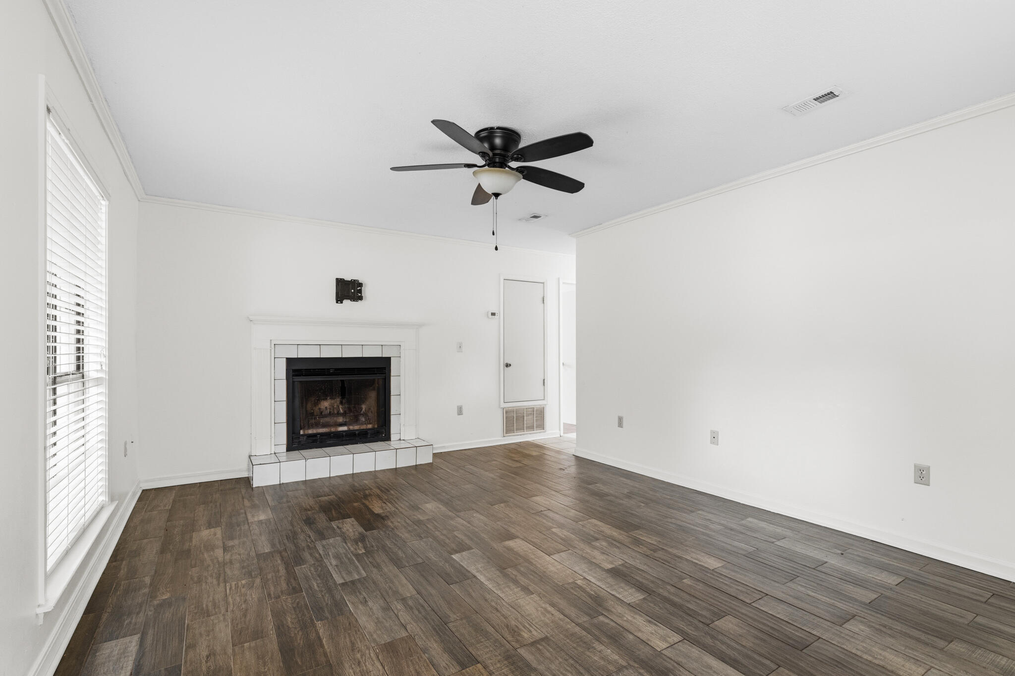 207 Pinoak Court Crestview, FL 32539 - Photo 4 of 33 wooden floor in an empty room with a window