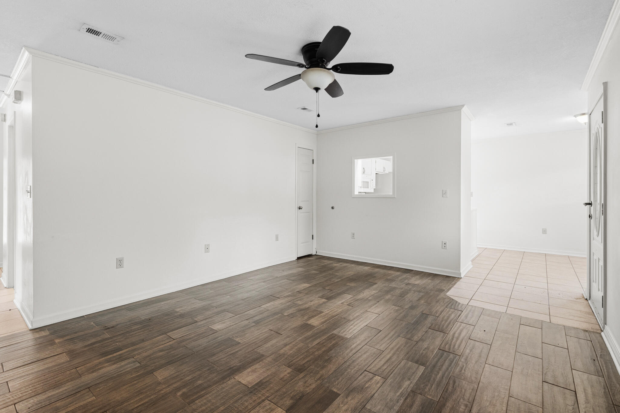 207 Pinoak Court Crestview, FL 32539 - Photo 5 of 33 an empty room with wooden floor and ceiling fan