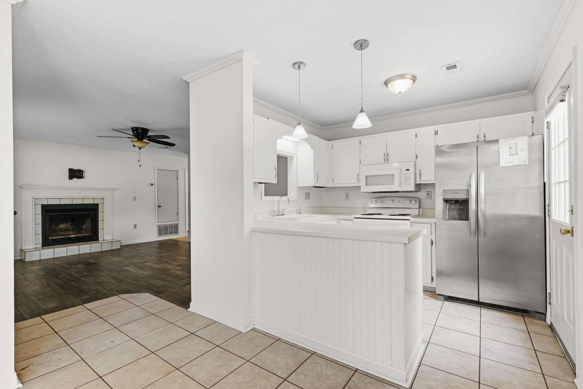 207 Pinoak Court Crestview, FL 32539 - Photo 7 of 33 a kitchen with kitchen island a counter top space a sink cabinets and stainless steel appliances