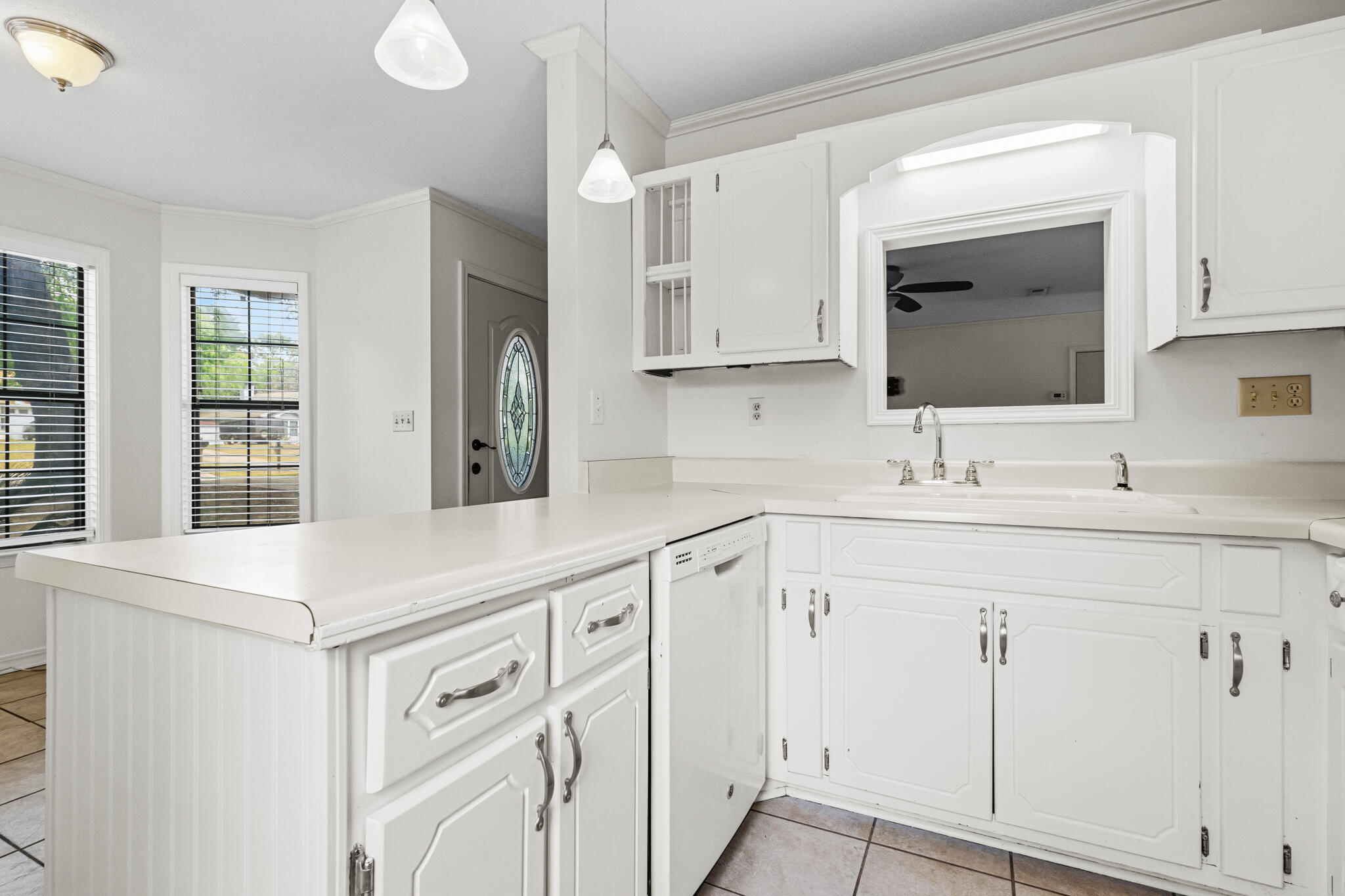 207 Pinoak Court Crestview, FL 32539 - Photo 8 of 33 a kitchen with white cabinets and sink