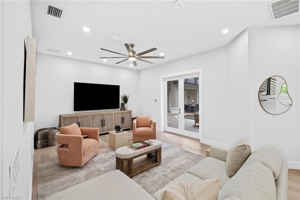 7834 Classics Drive Naples, FL 34113 - Photo 18 of 50 a living room with furniture and a flat screen tv