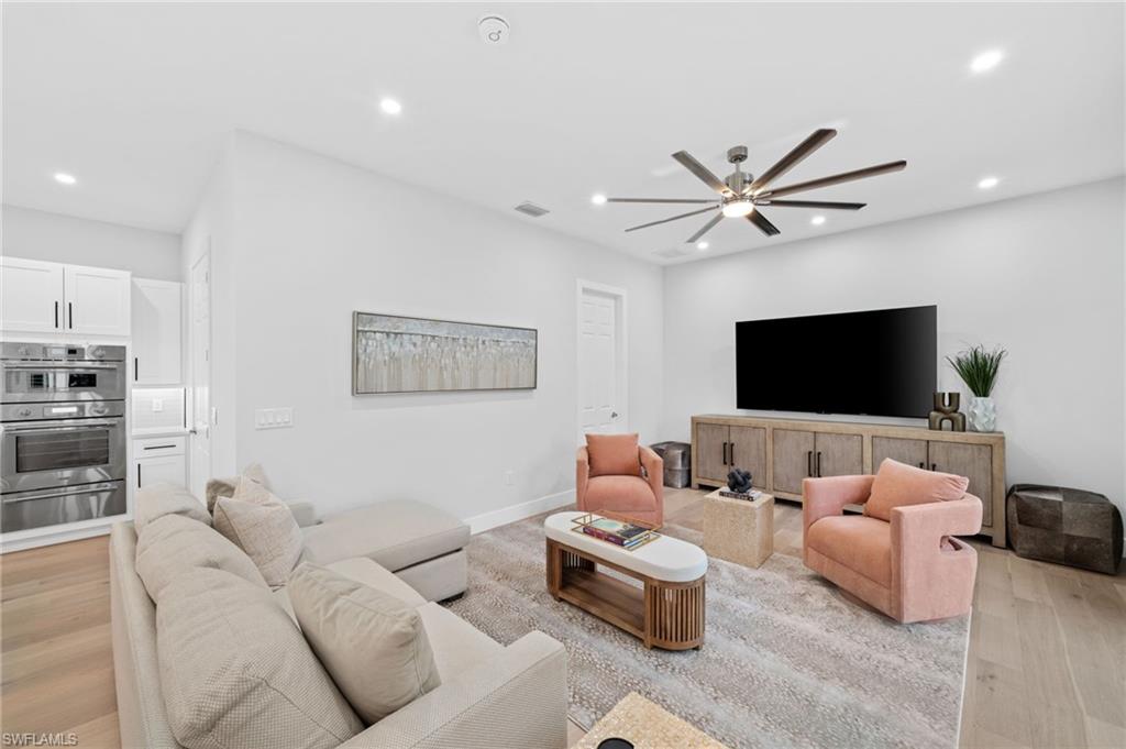 7834 Classics Drive Naples, FL 34113 - Photo 19 of 50 a living room with furniture and a flat screen tv