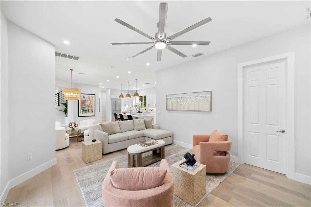 7834 Classics Drive Naples, FL 34113 - Photo 20 of 50 a living room with furniture and a chandelier