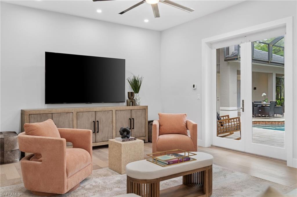 7834 Classics Drive Naples, FL 34113 - Photo 22 of 50 a living room with furniture and a flat screen tv