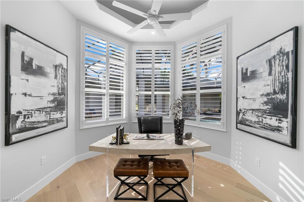 7834 Classics Drive Naples, FL 34113 - Photo 24 of 50 a living room with furniture and large windows