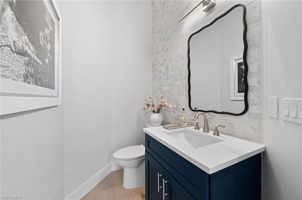 7834 Classics Drive Naples, FL 34113 - Photo 25 of 50 a bathroom with a sink vanity and a toilet