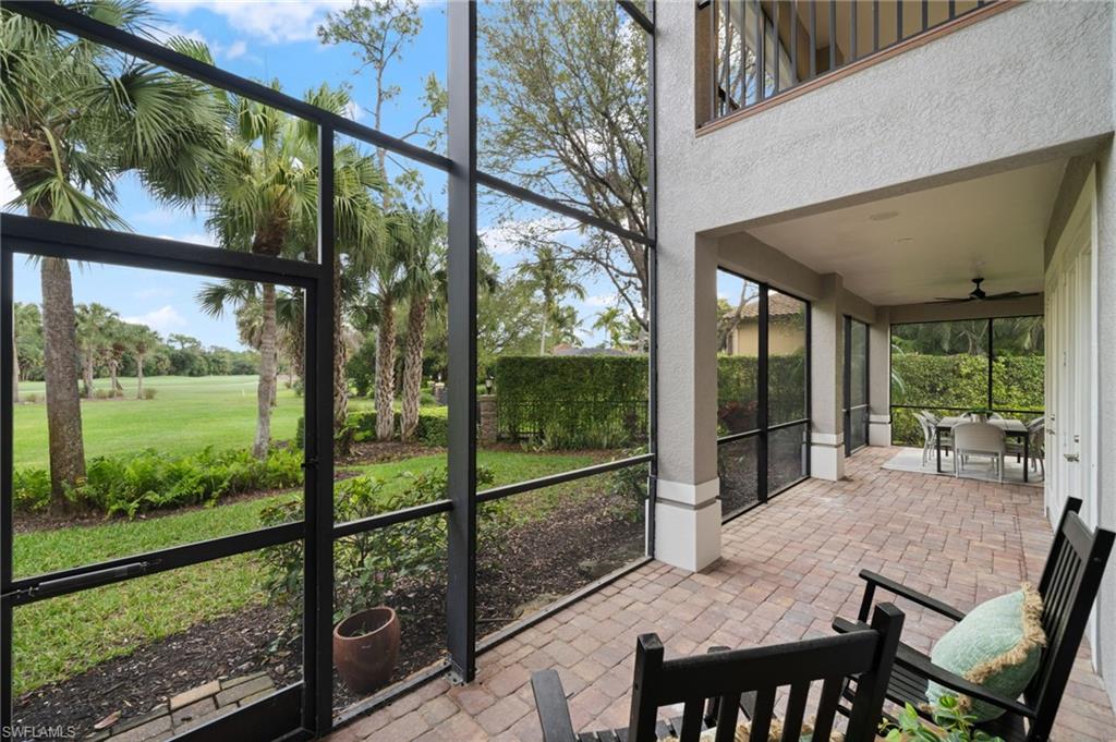 7834 Classics Drive Naples, FL 34113 - Photo 31 of 50 a view of a patio with a table chairs and balcony