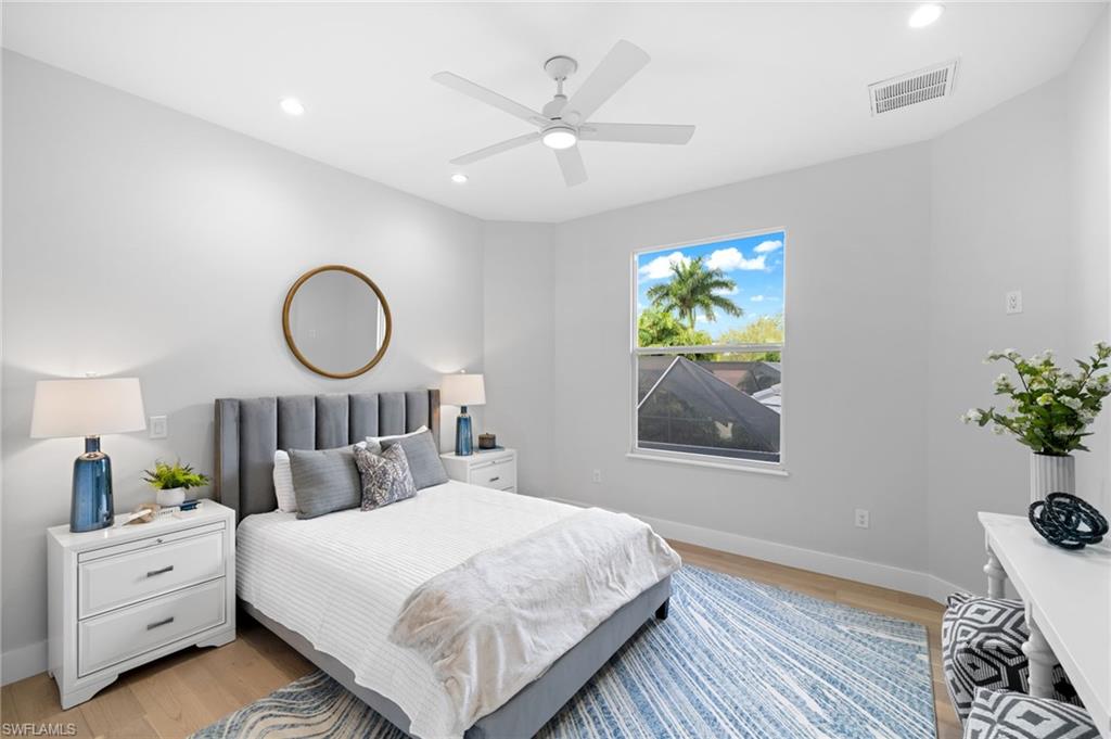 7834 Classics Drive Naples, FL 34113 - Photo 34 of 50 a bedroom with a large bed and a chandelier
