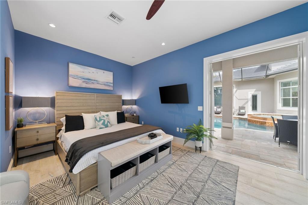 7834 Classics Drive Naples, FL 34113 - Photo 41 of 50 a bedroom with a bed and a flat screen tv