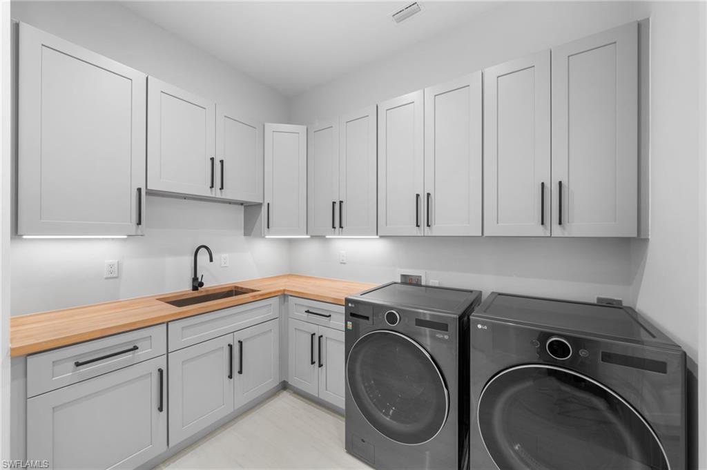 7834 Classics Drive Naples, FL 34113 - Photo 44 of 50 a utility room with sink dryer and washer