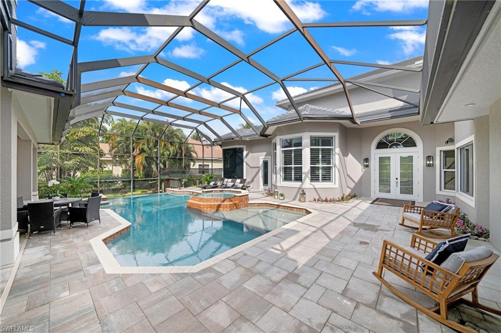 7834 Classics Drive Naples, FL 34113 - Photo 46 of 50 a view of swimming pool with outdoor seating