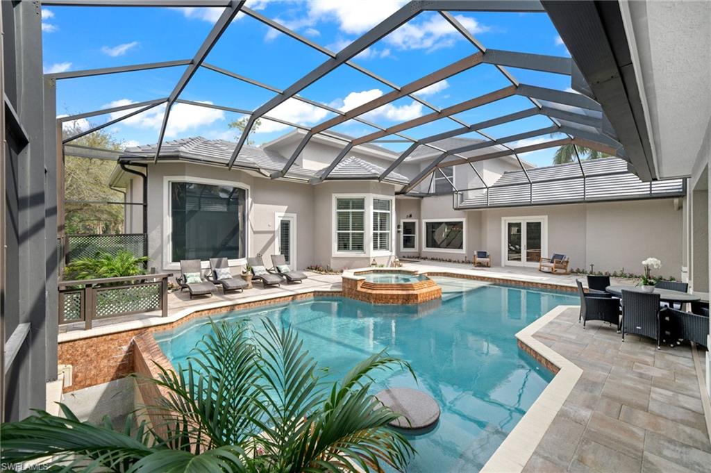 7834 Classics Drive Naples, FL 34113 - Photo 47 of 50 a view of swimming pool with seating area