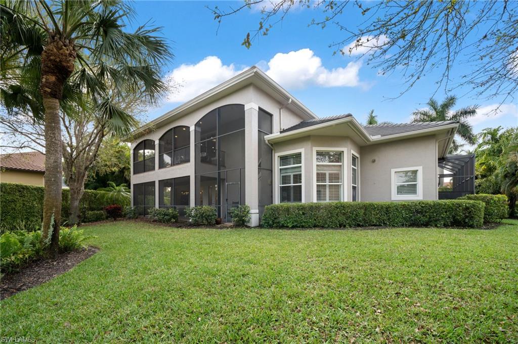 7834 Classics Drive Naples, FL 34113 - Photo 48 of 50 a front view of a house with a garden