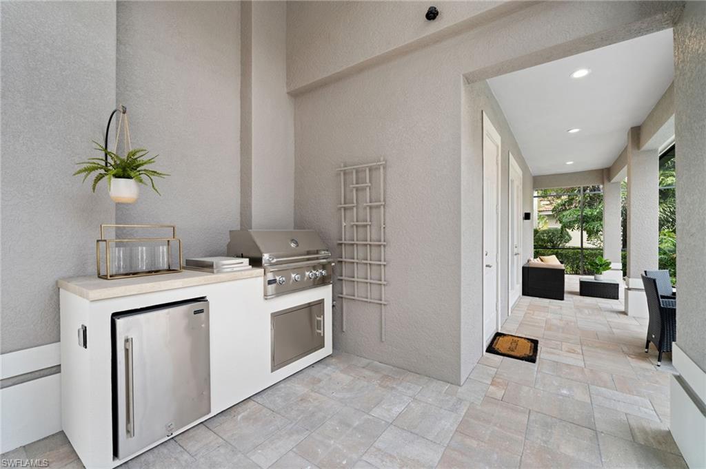 7834 Classics Drive Naples, FL 34113 - Photo 50 of 50 a kitchen with a stove and cabinets