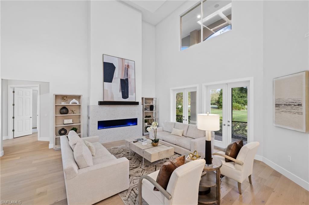 7834 Classics Drive Naples, FL 34113 - Photo 6 of 50 a living room with fireplace furniture and a large window
