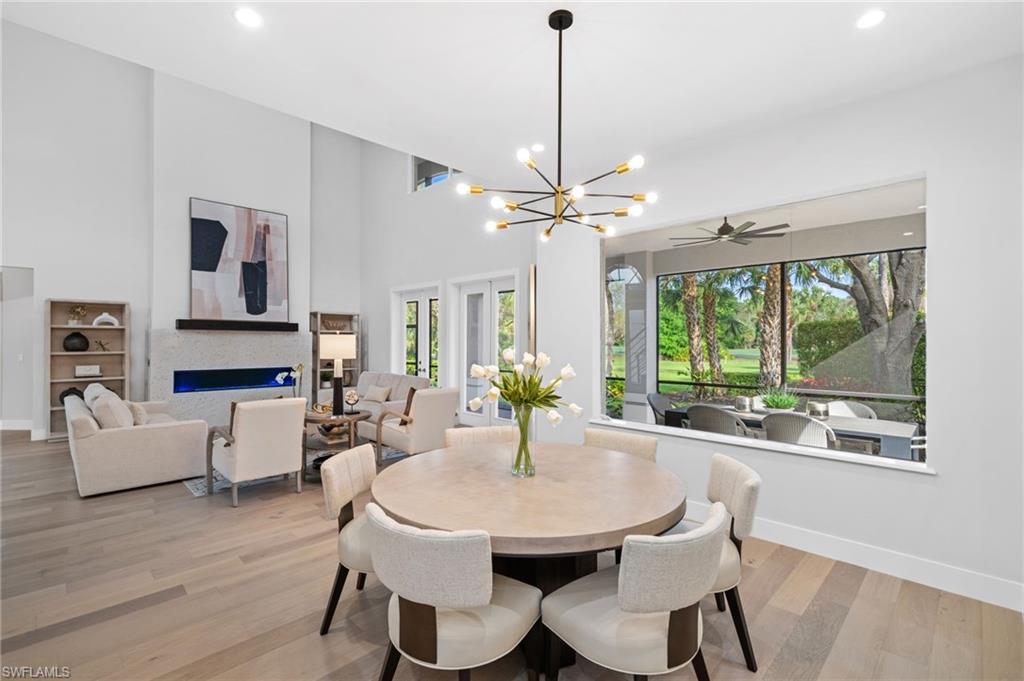 7834 Classics Drive Naples, FL 34113 - Photo 7 of 50 a view of a dining room with furniture window and wooden floor