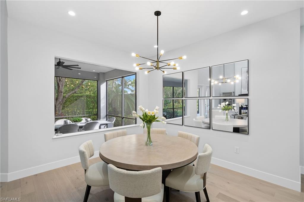 7834 Classics Drive Naples, FL 34113 - Photo 8 of 50 a kitchen with a table and chairs