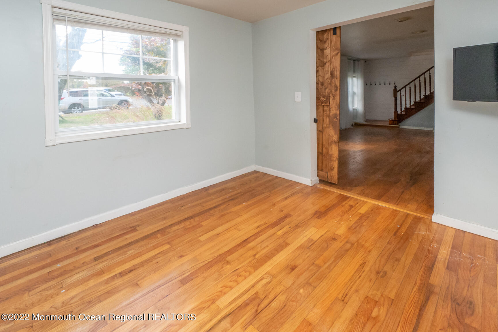 965 Leonardville Road Atlantic Highlands, NJ 07716 - Photo 7 of 29 a view of empty room with wooden floor and fan