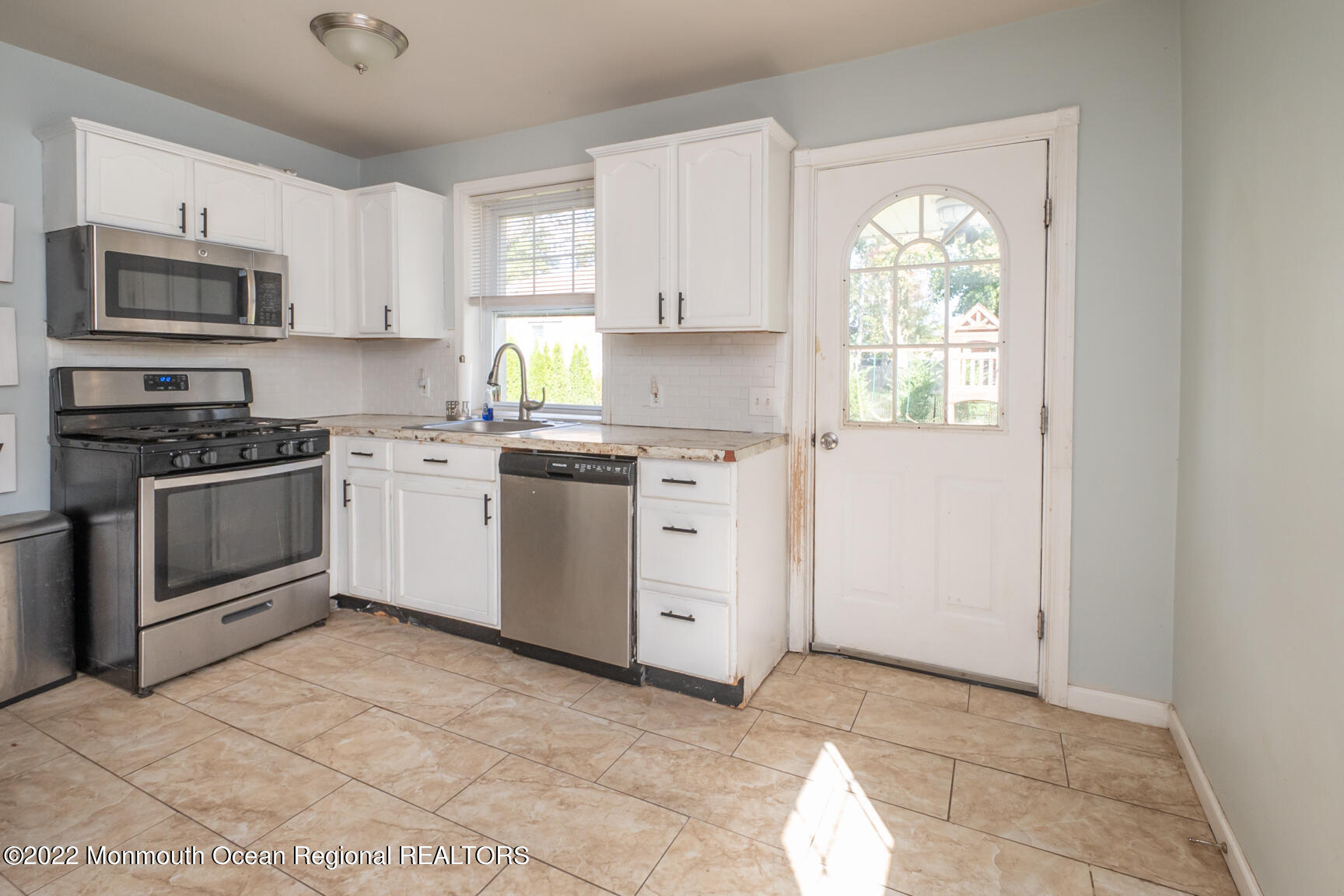 965 Leonardville Road Atlantic Highlands, NJ 07716 - Photo 9 of 29 a kitchen with white cabinets appliances and a window