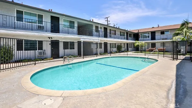 a view of a house with swimming pool and porch