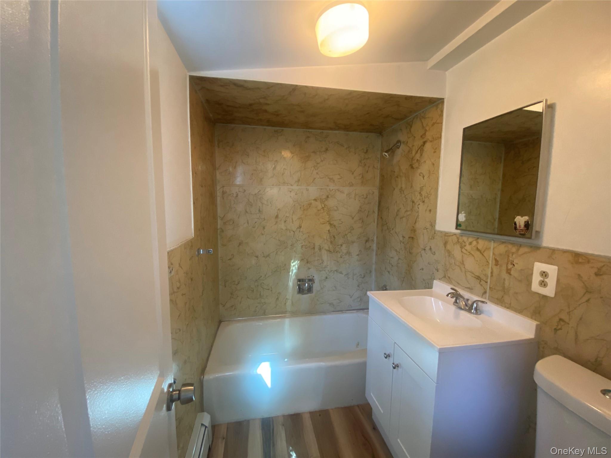 101 Randall Street, Unit A Florida, NY 10921 - Photo 9 of 11 a bathroom with a sink and mirror