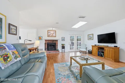 a kitchen with stainless steel appliances a refrigerator and wooden floor