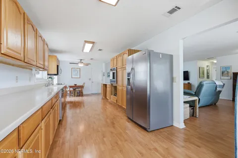 a kitchen with stainless steel appliances granite countertop a stove microwave and refrigerator