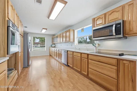 a spacious bedroom with a bed and a view of bathroom