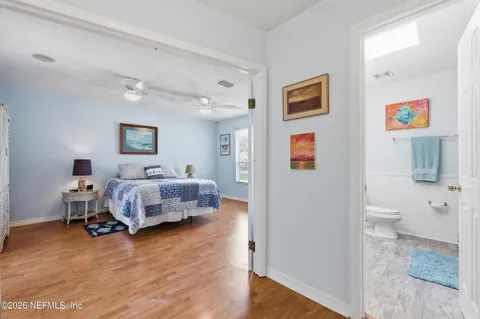 a spacious bedroom with a bed and a table in it